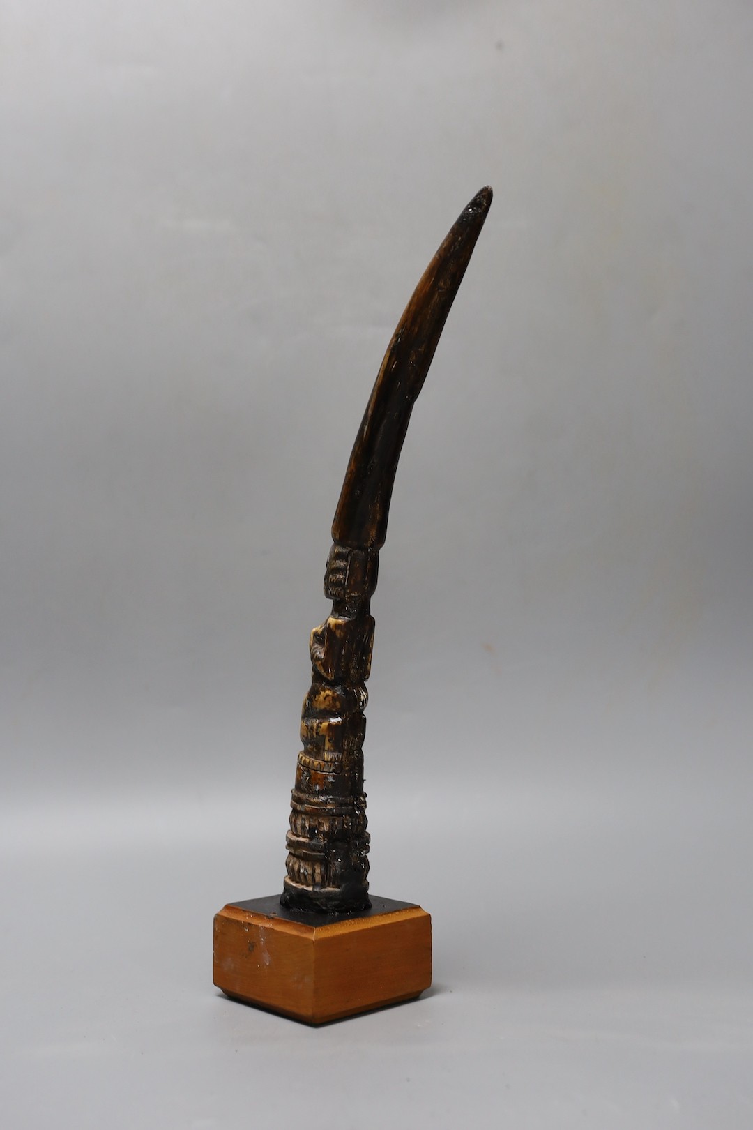 An African carved ivory divination tapper, probably Yoruba tribe on stand, 35 cms high.